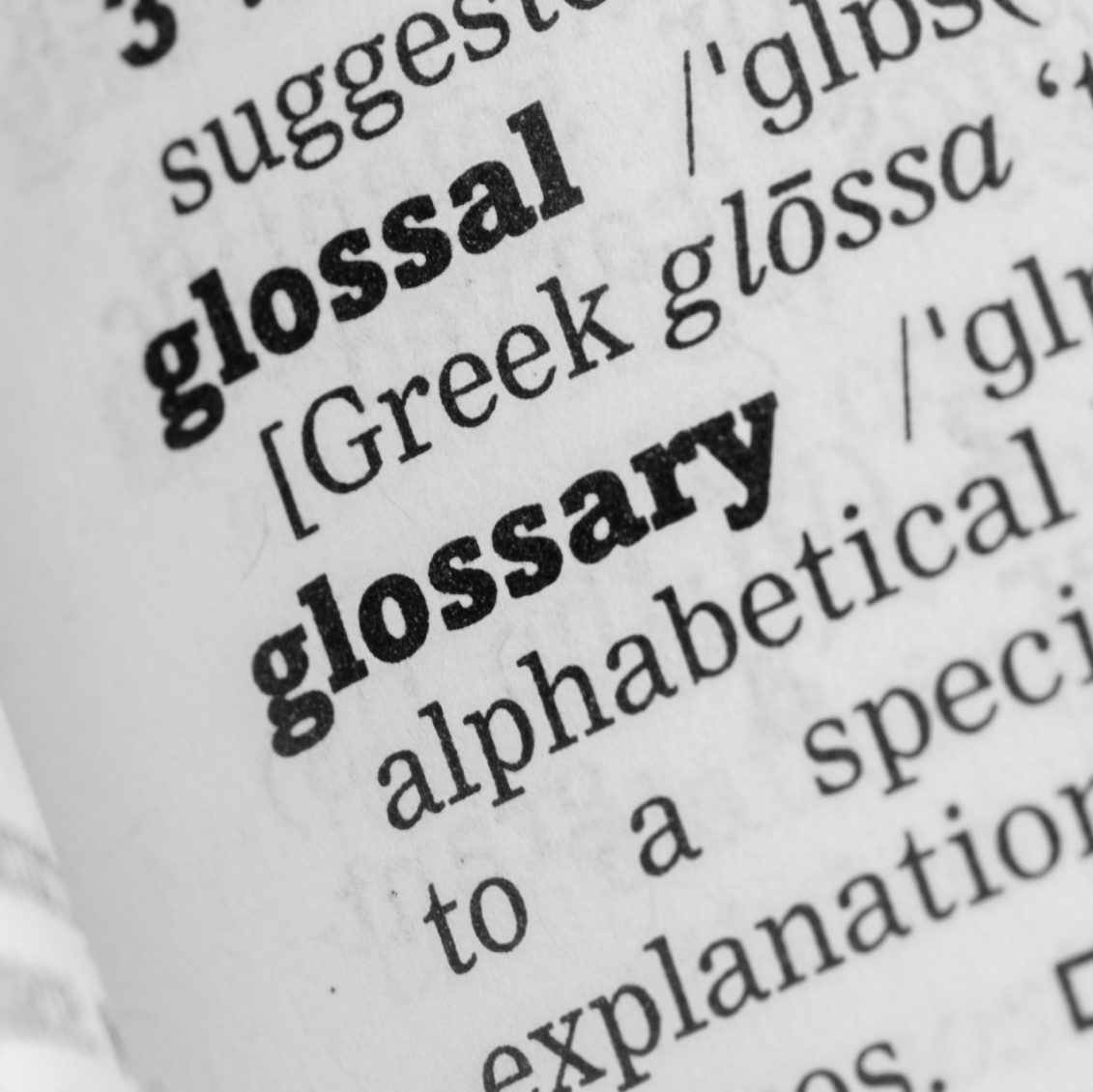 Dictionary, single word close up of the word glossary.